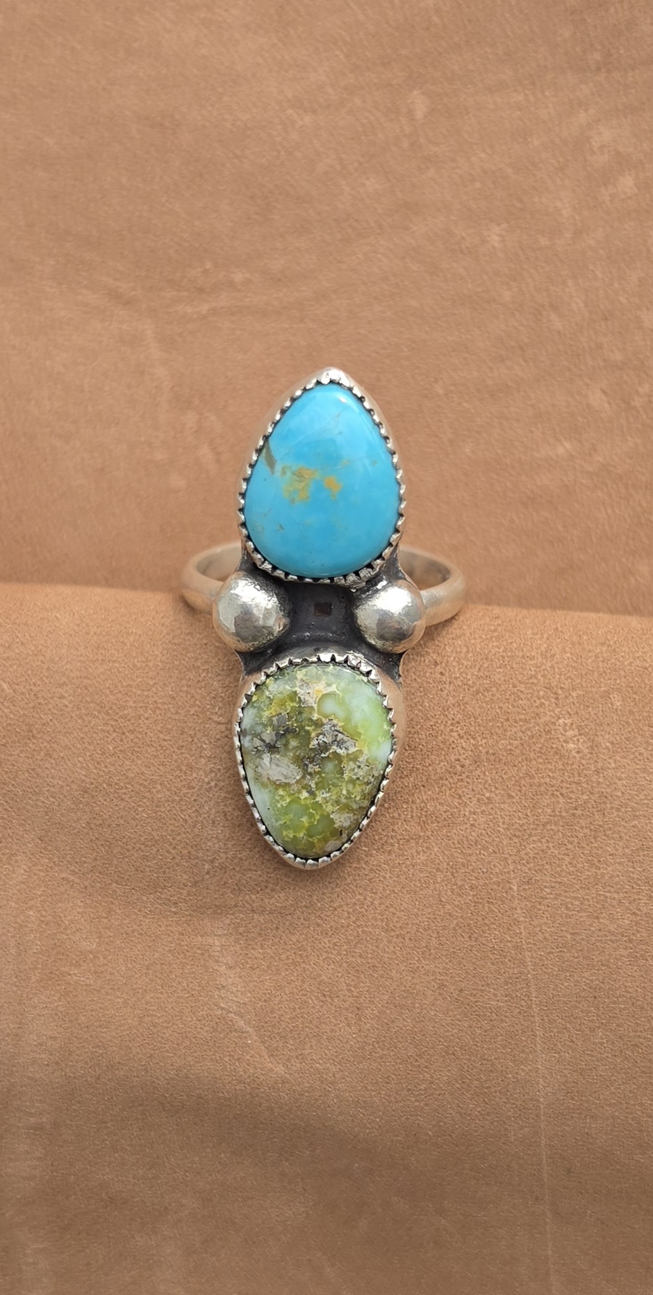 A sterling silver ring set with palomino and Sonoran turquoise